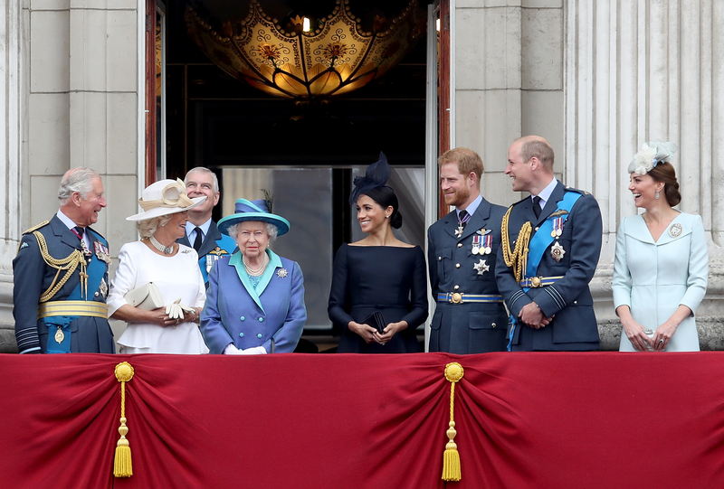 (L-R) Prince Charles, Prince of Wales, Camilla, Duchess of Cornwall, Prince Andrew, Duke of York, Queen Elizabeth II, Meghan, Duchess of Sussex, Prince Harry, Duke of Sussex, Prince William, Duke of Cambridge and Catherine, Duchess of Cambridge watch the RAF flypast on the balcony of Buckingham Palace to mark the centenary of the RAF on July 10, 2018 in London, England.